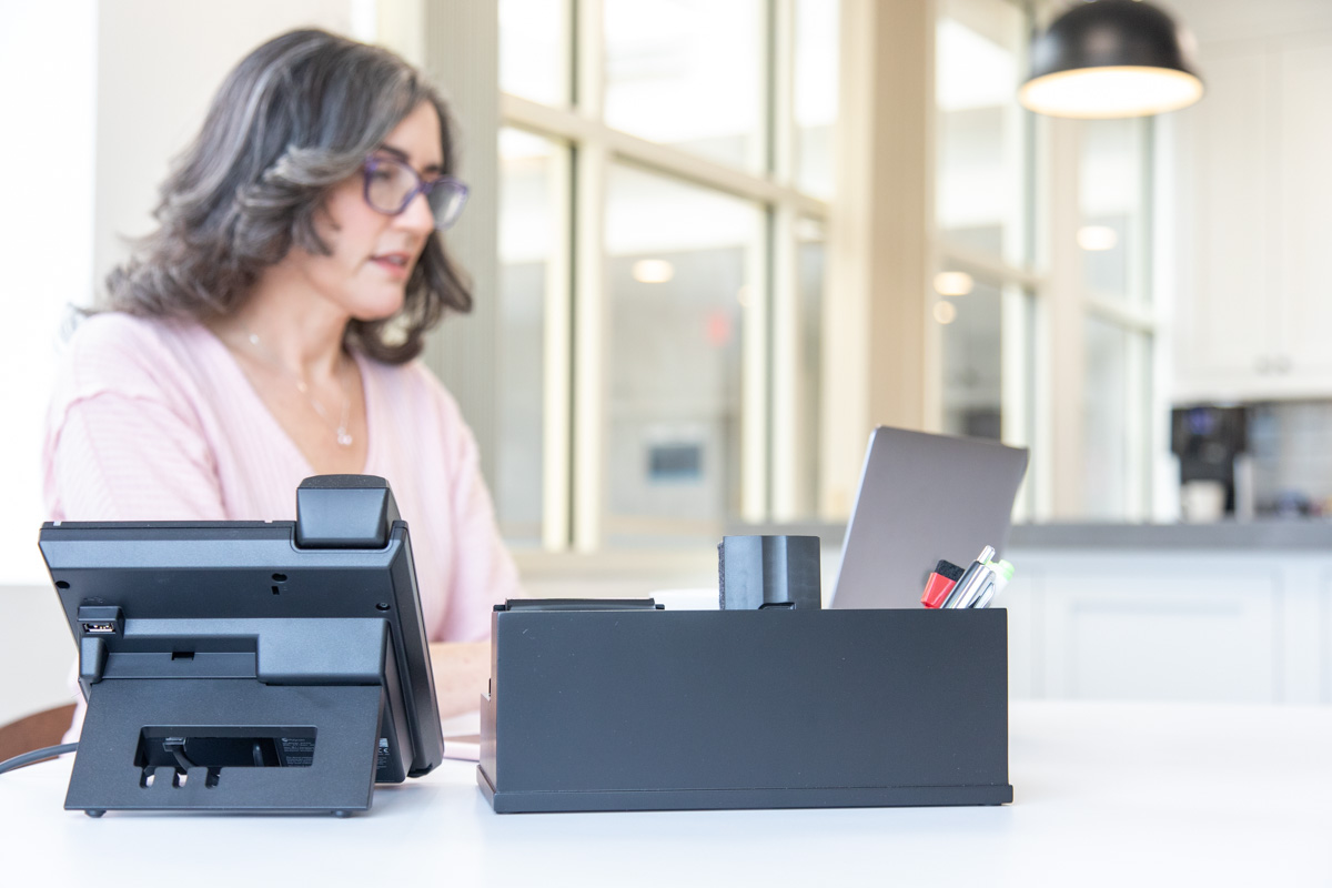A member working at her desk at Workspace Hingham