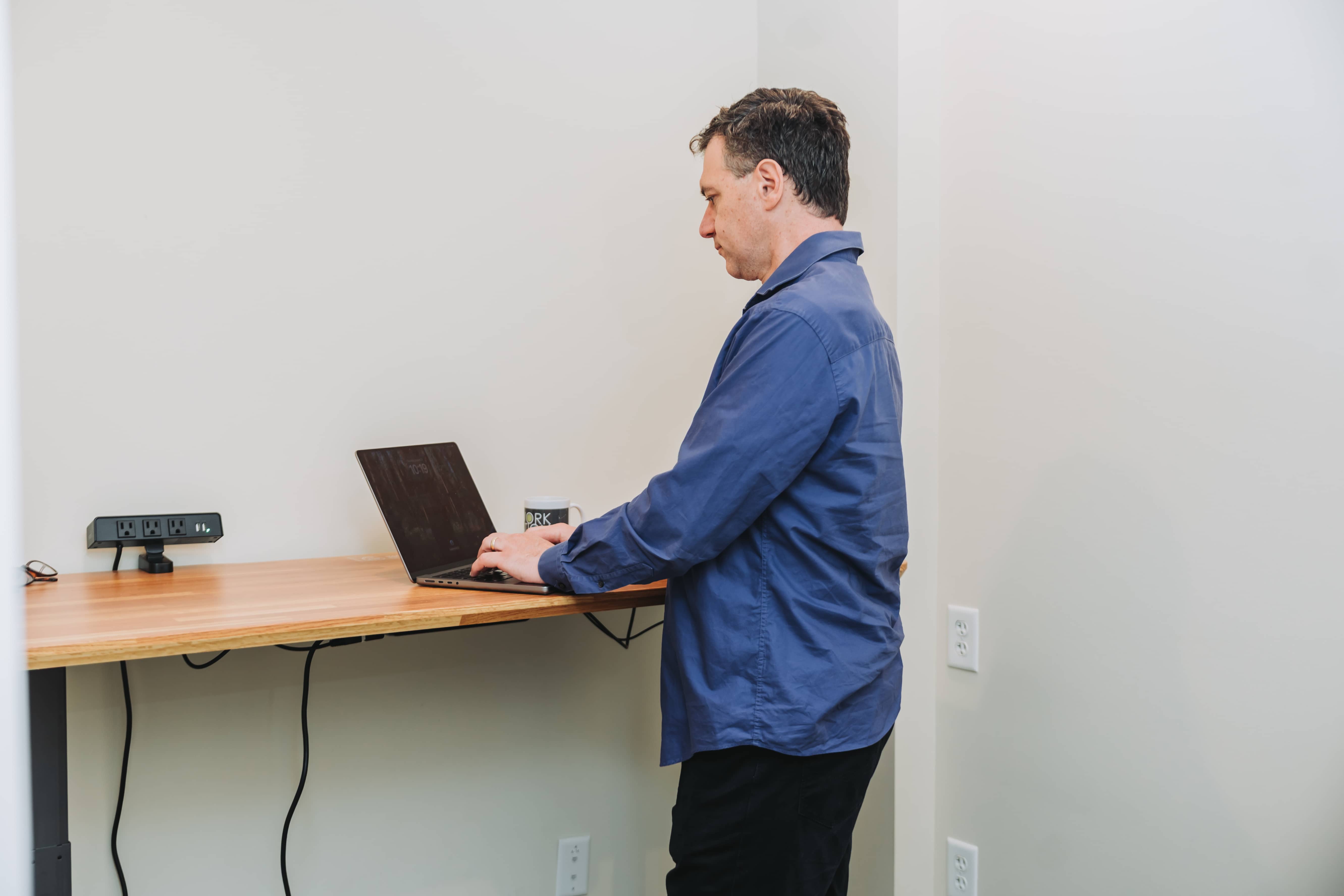 A member working at a standing desk at Workspace Cohasset