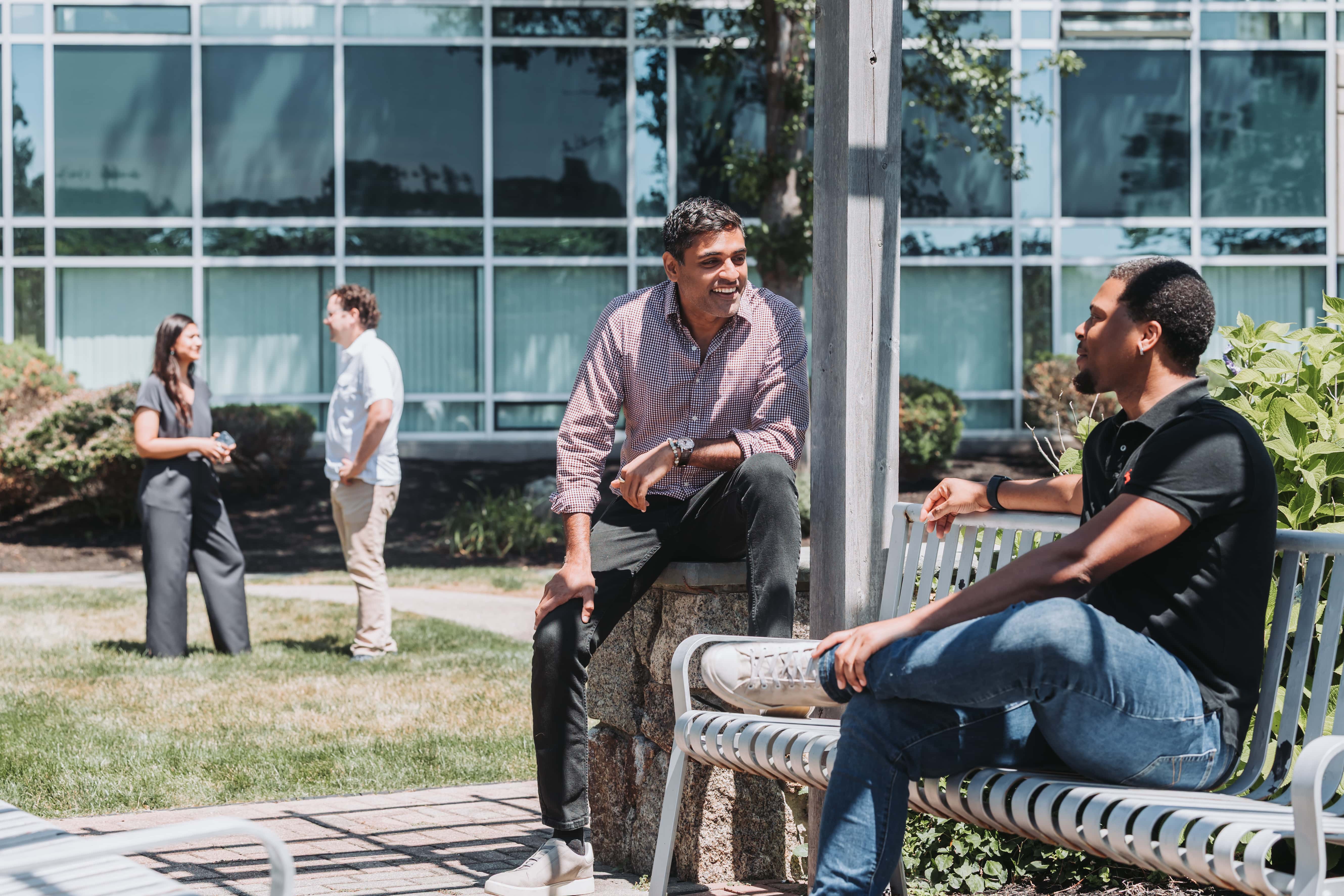 Members chatting outside on the Cummings Center benches at Workspace Beverly