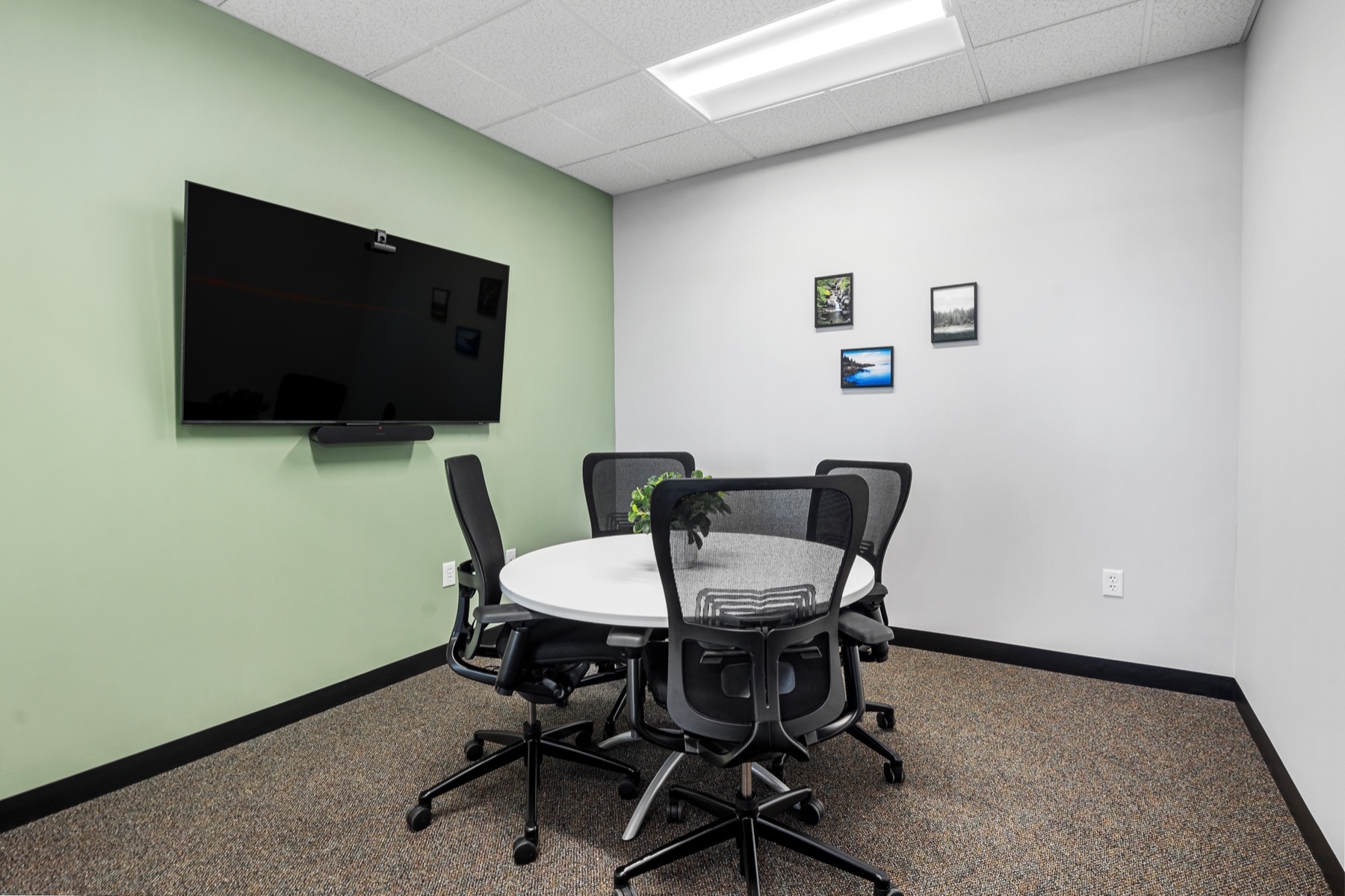 A four-person huddle room with video conferencing at Workspace Beverly