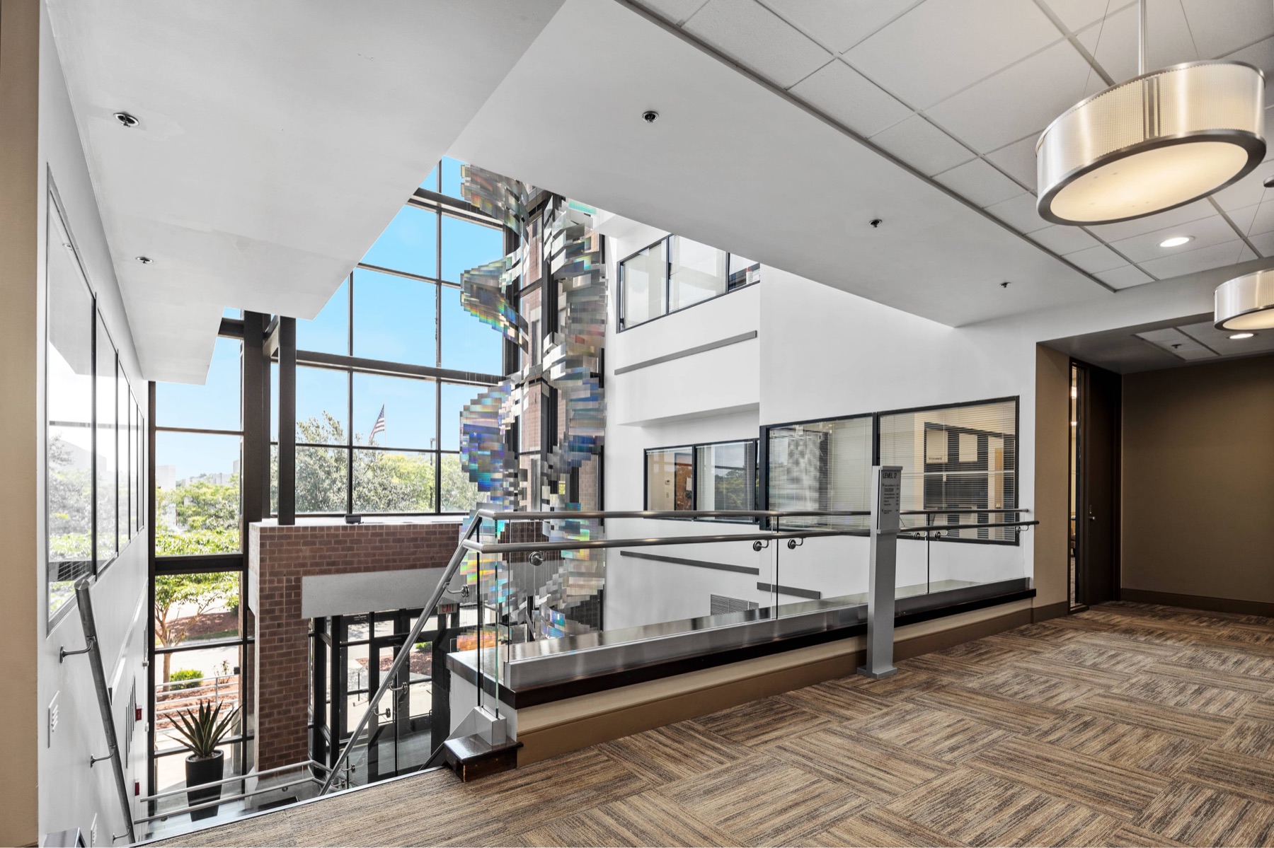 The second-floor landing at Workspace Braintree overlooking the atrium windows