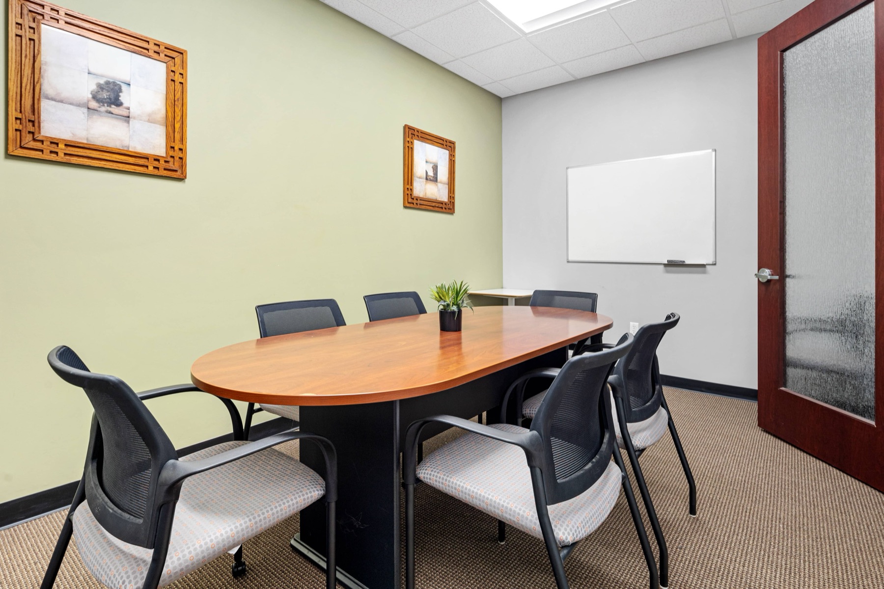A six-seat conference room at Workspace Canton