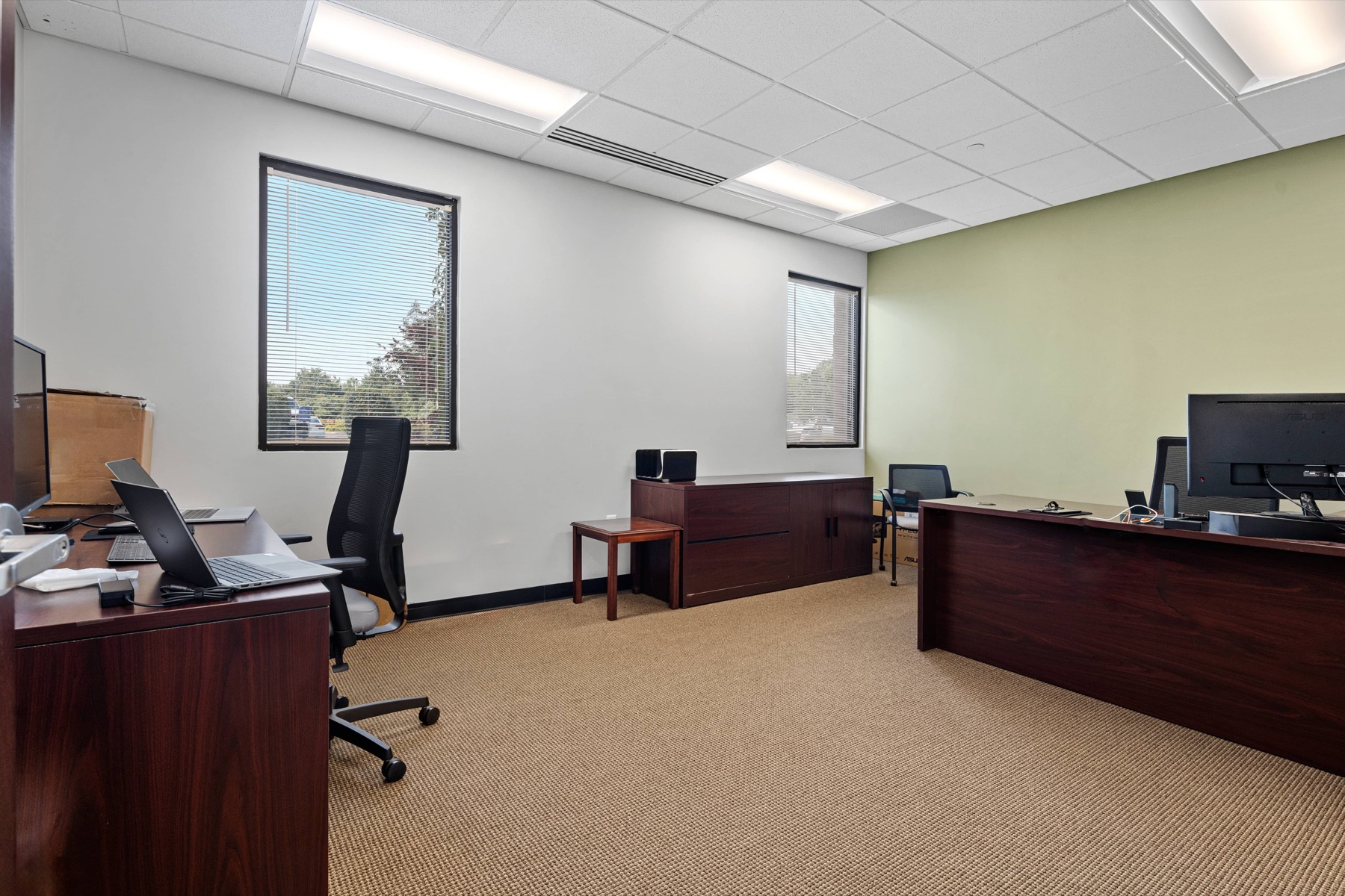 A team office with desks and a media console at Workspace Canton