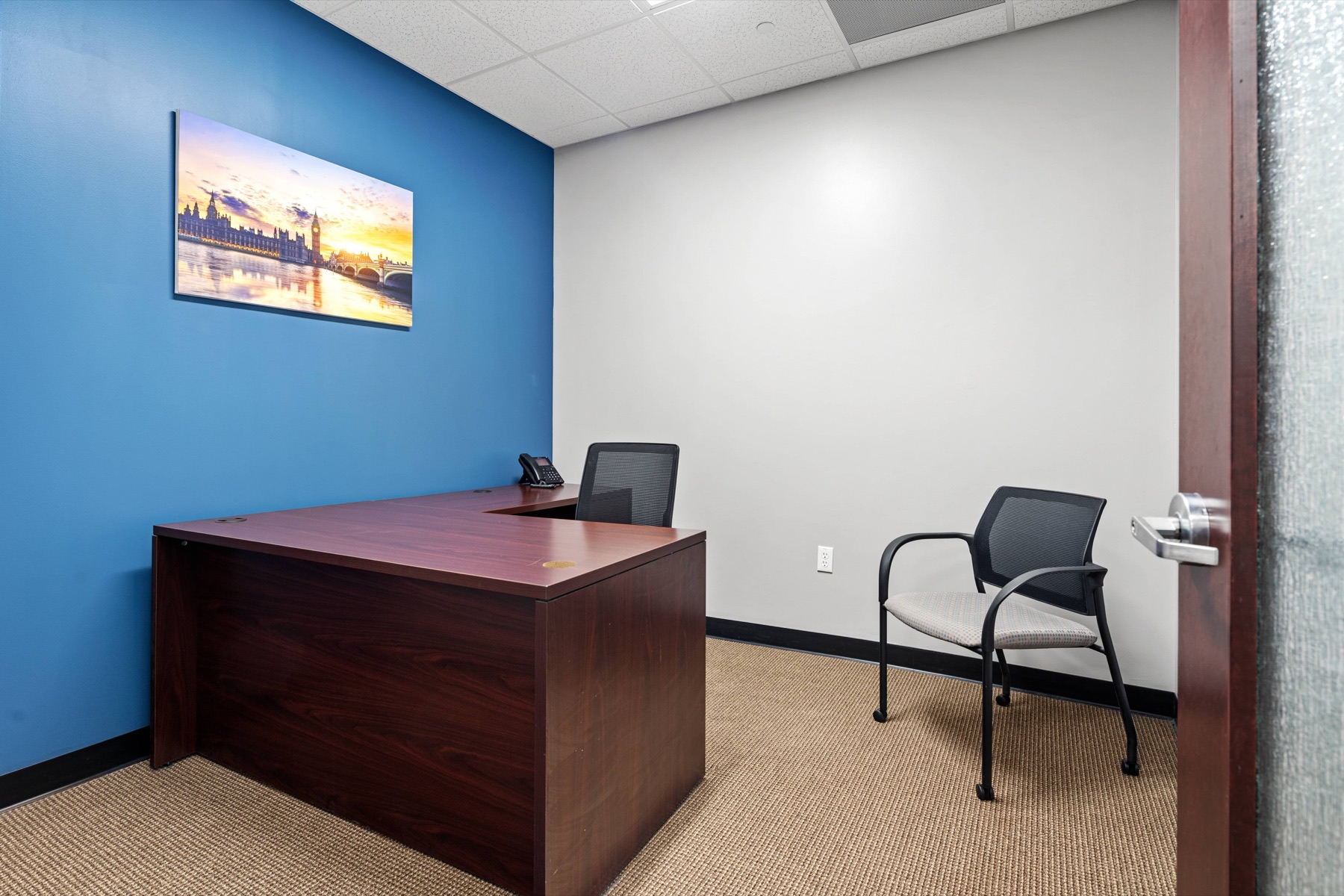 A private office with an L-shaped desk at Workspace Canton