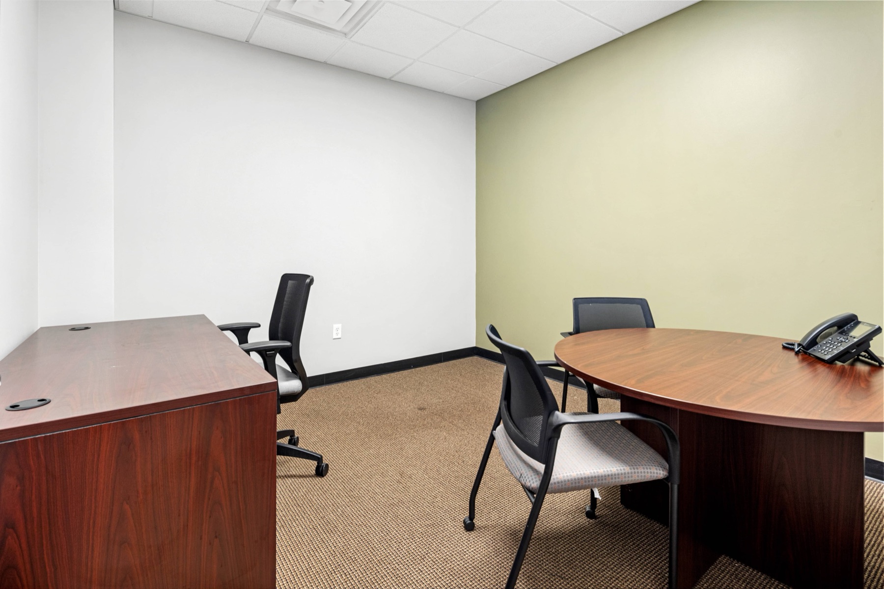 An office with a round meeting table at Workspace Canton
