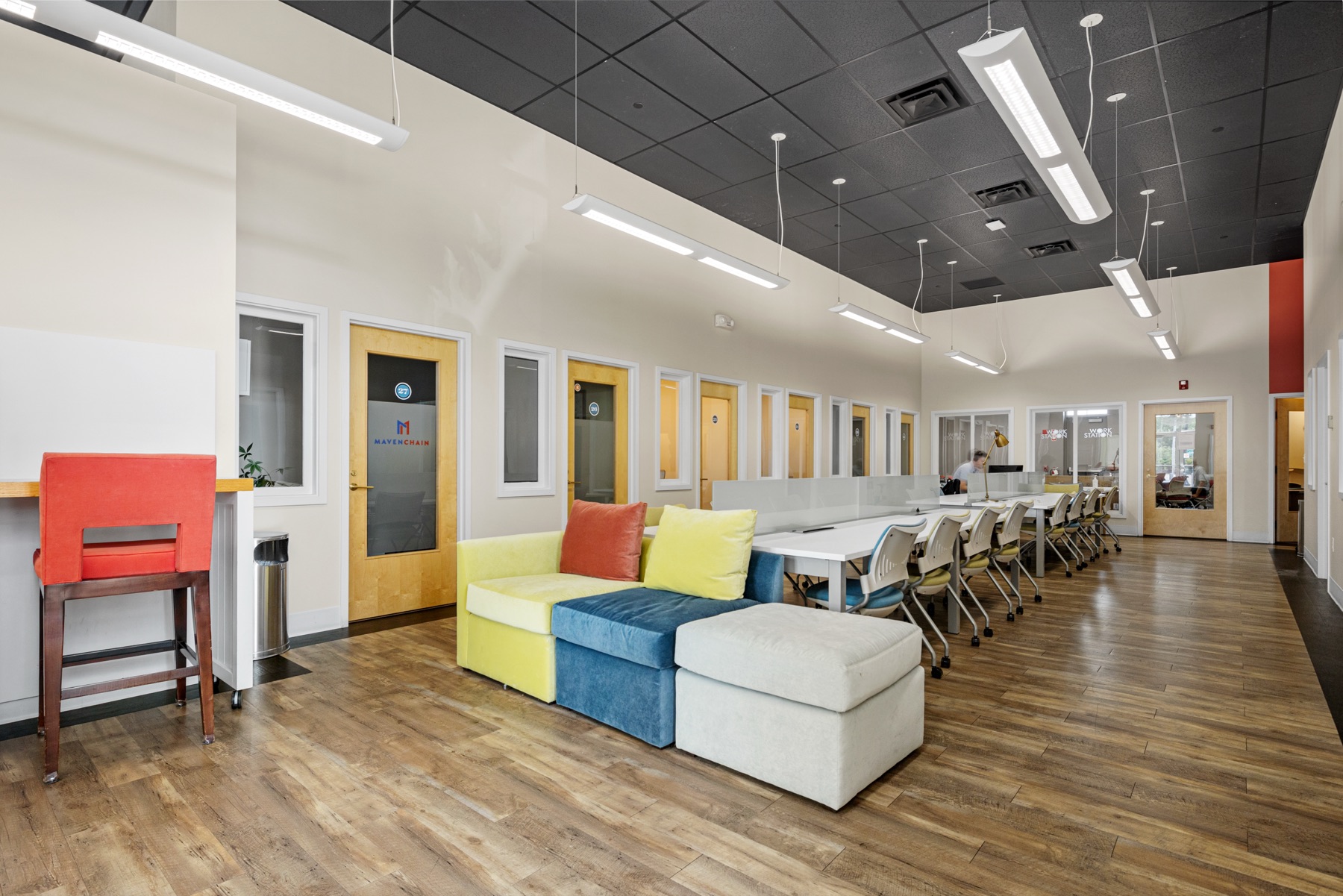 Lounge seating beside the shared coworking table at Workspace Cohasset