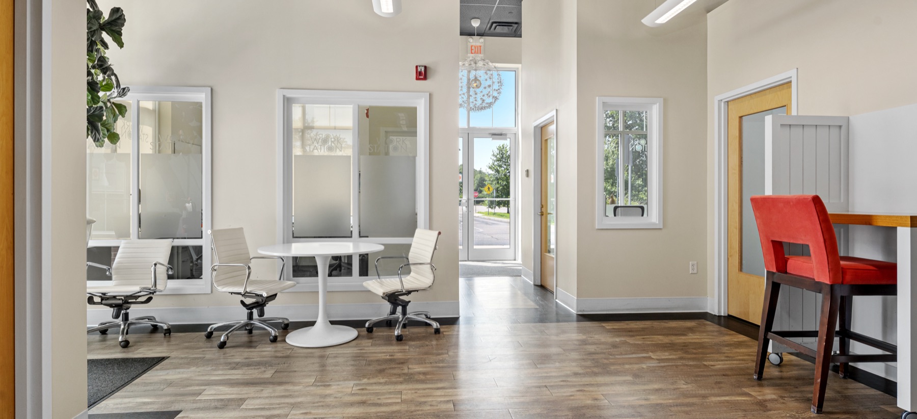 The reception area at Workspace Cohasset with glass-walled offices and a cafe-height counter