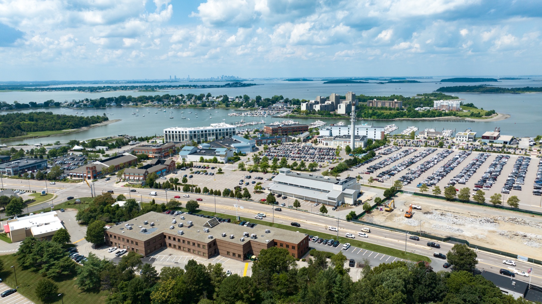 Aerial view of Workspace Hingham at the Hingham Shipyard with the Boston skyline beyond