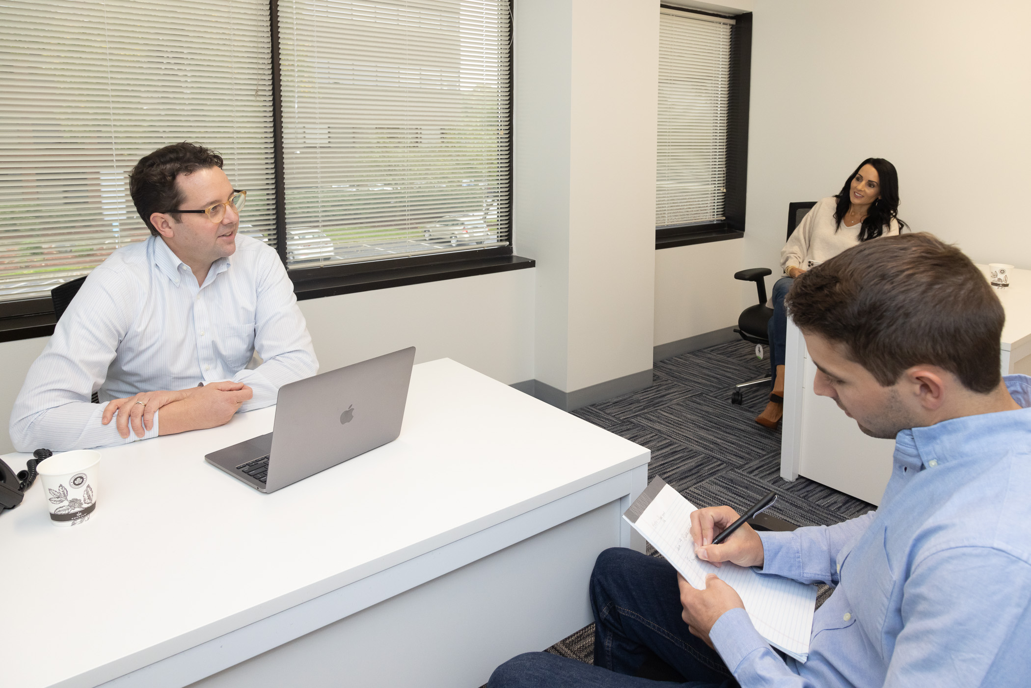 Members meeting around a desk in a Workspace Braintree office