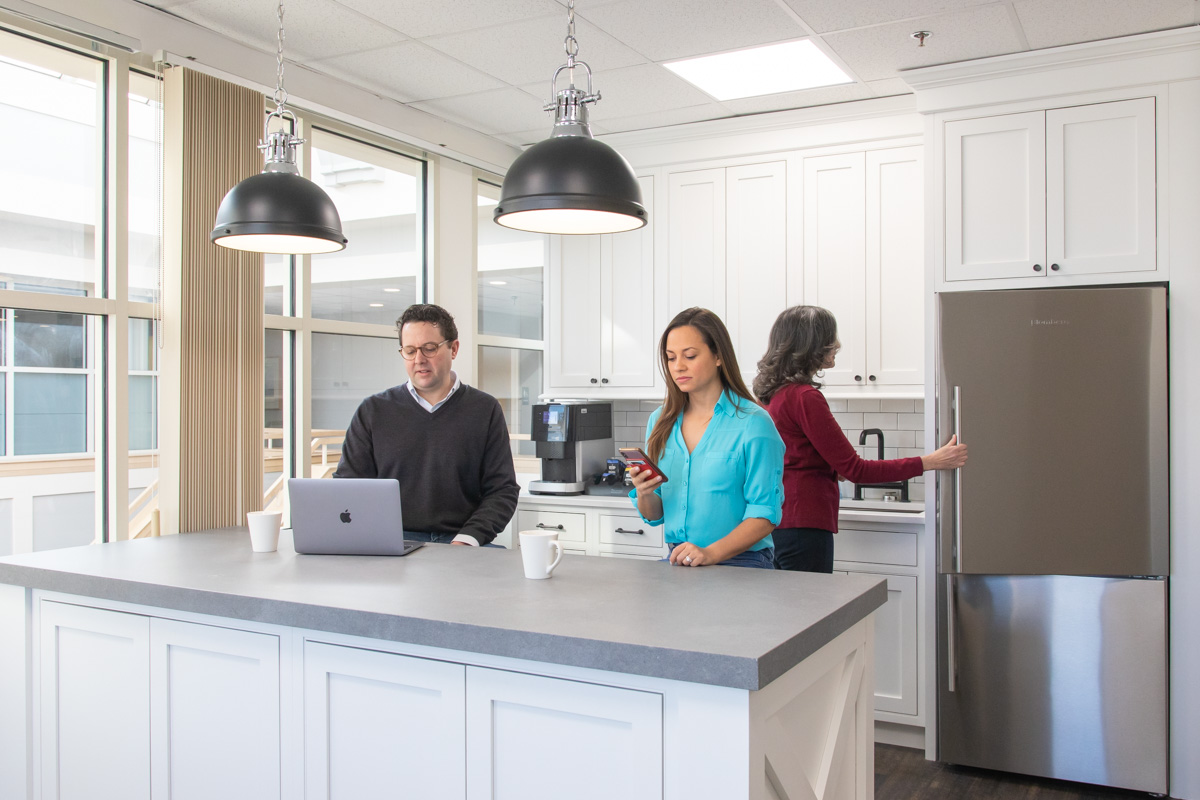 Members working at the kitchen island at Workspace Hingham