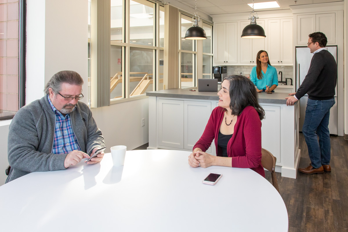 Members catching up over coffee at Workspace Hingham